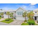 Charming two-story beach home featuring palm trees, a front porch, and a two-car garage at 540 Chanted Dr., Murrells Inlet, SC 29576
