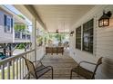 Relaxing covered porch with seating, ceiling fan, and views of the street at 6001- P16A S Kings Highway, Myrtle Beach, SC 29575