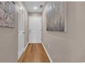 Hallway with wood floors, neutral walls, and white doors providing a sense of spaciousness at 627 Waterway Village Blvd. # 8E, Myrtle Beach, SC 29579
