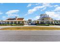 View of community clubhouse showcasing its inviting architecture and well-manicured surroundings at 7179 Shooting Star Way, Myrtle Beach, SC 29579