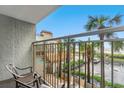 Balcony view of a condo complex overlooking a tiki bar, pool, palm trees, and the beach, with outdoor seating at 7200 N Ocean Blvd. # 257, Myrtle Beach, SC 29572