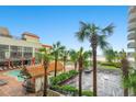 Coastal condo community with pool, tiki bar, palm trees, and distant beach views from a sunny parking area at 7200 N Ocean Blvd. # 257, Myrtle Beach, SC 29572
