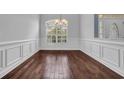 Formal dining room with hardwood floors, wainscoting, and a large window offering plenty of natural light at 760 Carolina Farms Blvd., Myrtle Beach, SC 29579