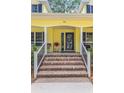 Inviting front porch with brick steps, black railings, and cozy seating, leading to front door at 786 Wild Oak Ln. Nw, Calabash, NC 28467