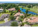 An aerial view of a beautiful home nestled among mature trees near a pond and golf course at 9737 Catalonia Ct., Myrtle Beach, SC 29579
