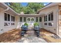 Inviting entrance with a double front door, flanked by matching windows and decorative seating areas at 103 Wofford Ln., Conway, SC 29526