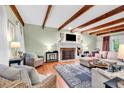 Bright living room with exposed wood beams, fireplace, and comfortable seating, perfect for gatherings at 1072 Chelsey Circle, Conway, SC 29526