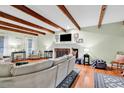 Comfortable living room with a fireplace, exposed beams, hardwood floors, and neutral decor at 1072 Chelsey Circle, Conway, SC 29526