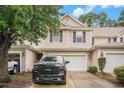 Charming two-story townhome with black shutters, a white garage door, and driveway with a black truck parked at 1120 Fairway Ln. # 1120, Conway, SC 29526