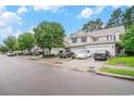 Street view of a row of charming townhomes with white garage doors, showcasing community living at its finest at 1120 Fairway Ln. # 1120, Conway, SC 29526