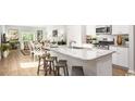 Open-concept kitchen featuring granite counters, stainless steel appliances, and a view to the dining and living areas at 136 Warner Crossing Way, Loris, SC 29569