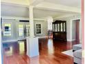 Spacious living room with hardwood floors, a column feature, and plenty of natural light at 1421 Shoreline Dr., Myrtle Beach, SC 29577