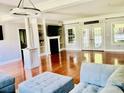 Bright and airy living room boasts hardwood floors, fireplace, and French doors to the backyard at 1421 Shoreline Dr., Myrtle Beach, SC 29577