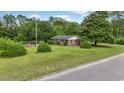 A pleasant view of the home's yard with the brick exterior at 169 Ole Maple St., Loris, SC 29569