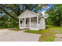Charming single-story home featuring a classic exterior and inviting front porch with ceiling fan at 1712 Singleton St., Conway, SC 29527