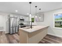Bright kitchen with stainless steel appliances, stone countertops, and stylish pendant lighting at 1712 Singleton St., Conway, SC 29527