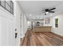Open-concept living space with wood floors leading to a modern kitchen island at 1712 Singleton St., Conway, SC 29527