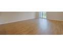 Spacious bedroom with wood-look flooring, base trim, and sliding glass door to the outside at 184 Sea Shell Dr. # 12, Murrells Inlet, SC 29576