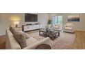 Bright living room featuring stylish furniture, a modern entertainment center, and a large patterned rug at 184 Sea Shell Dr. # 12, Murrells Inlet, SC 29576