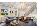 Cozy living room featuring vaulted ceiling, staircase, and comfortable seating arrangements at 1930 Lake View Circle, Myrtle Beach, SC 29575