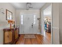 Inviting foyer with hardwood floors, a decorative chest, and a view into an adjacent room at 200 Silverbelle Blvd., Longs, SC 29568