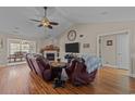 Comfortable living room with vaulted ceilings, a fireplace, and a view into the dining area at 200 Silverbelle Blvd., Longs, SC 29568
