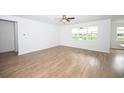 Open living room with hardwood floors and an abundance of natural light at 2002 Sweetflag Dr., Longs, SC 29568