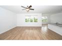Bright living area with hardwood floors and large windows offering serene backyard views at 2002 Sweetflag Dr., Longs, SC 29568