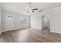 Bright, open living room with hardwood floors and a ceiling fan, featuring a window with natural light at 201 Gray Owl Dr., Conway, SC 29527