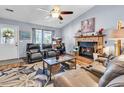 Bright living room features a fireplace, ceiling fan, and plenty of natural light at 201 Surrey Ln., Myrtle Beach, SC 29579
