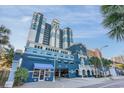 Striking blue and white multistory resort building featuring an attractive entrance and drive under parking at 2201 S Ocean Blvd. # 103, Myrtle Beach, SC 29577