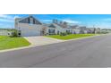 Street view of a row of charming homes, each with manicured lawns and inviting curb appeal at 223 Lakota Loop, Longs, SC 29568