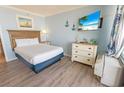Cozy bedroom featuring a queen bed, nautical decor, and a flat-screen TV for ultimate comfort and relaxation at 2311 S Ocean Blvd. # 437, Myrtle Beach, SC 29577