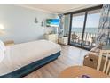 Inviting bedroom offering balcony access with ocean views, complemented by nautical decor and a cozy seating area at 2311 S Ocean Blvd. # 437, Myrtle Beach, SC 29577