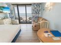 Comfortable living area with a recliner, table, and balcony access, offering a relaxing space with ocean views at 2311 S Ocean Blvd. # 437, Myrtle Beach, SC 29577