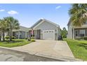Charming single-story home with a well-manicured lawn, an attached garage, and inviting curb appeal at 236 Palm Cove Circle, Myrtle Beach, SC 29588