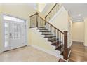 Elegant foyer features a grand staircase with decorative wrought iron railing and hardwood floors at 28 Grey Moss Rd., Murrells Inlet, SC 29576