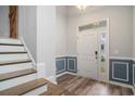 Inviting entryway featuring wood-look floors, wainscoting, a chandelier and a staircase at 294 Splendor Circle, Murrells Inlet, SC 29576