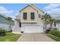Charming yellow two-story home with a white garage, black shutters and well-manicured lawn at 294 Splendor Circle, Murrells Inlet, SC 29576