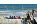 Scenic beach view with sun umbrellas and chairs, perfect for relaxation by the ocean at 33 Hope Ln., Pawleys Island, SC 29585