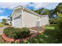 Back exterior of single story home with a two car garage and manicured lawn at 333 Walden Lake Rd., Conway, SC 29526