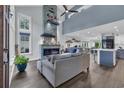 Inviting living room with stone fireplace, high ceilings, large windows, and an open-concept design at 35 Easter Lilly Ct., Murrells Inlet, SC 29576