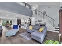 Bright, open living area with modern staircase, and seamless flow to the kitchen and dining spaces at 35 Easter Lilly Ct., Murrells Inlet, SC 29576