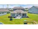 Home featuring a backyard with a patio, outdoor seating, and well-maintained landscaping at 356 Ocean Commons Dr., Surfside Beach, SC 29575