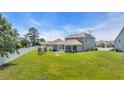 Picture of the home's backyard featuring a privacy fence and patio with seating at 356 Ocean Commons Dr., Surfside Beach, SC 29575