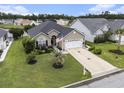 Inviting one-story home featuring a well-kept lawn, palm tree, and a two-car garage at 388 Sea Turtle Dr., Myrtle Beach, SC 29588