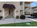 Inviting condo entrance with covered awning and manicured landscaping at 4290 Pinehurst Circle # B3, Little River, SC 29566
