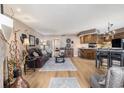 Open-concept living room with wood floors and adjacent kitchen at 4290 Pinehurst Circle # B3, Little River, SC 29566