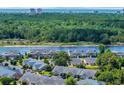 Beautiful aerial view showcases waterfront homes surrounded by dense trees with city skyline in the distance at 4520 Lighthouse Dr. # 29B, Little River, SC 29566