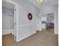 Inviting hallway with tile floors leads to a well-lit bathroom, kitchen, and open living space at 4520 Lighthouse Dr. # 29B, Little River, SC 29566